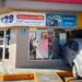 Automóvil gris Chevrolet Aveo incrustado en la fachada de una tienda de conveniencia